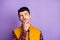 Photo of minded smart young man look empty space hold hand chin idea plan isolated on purple color background