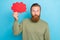 Photo of minded thoughtful guy with ginger hairdo dressed khaki long sleeve look at red mind cloud isolated on blue