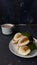 Photo of a mini martabak folded on a plate and a cup of soy milk