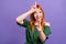 Photo of mocking childish young lady wear green blouse sowing loser sign pointing finger you isolated purple color