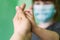 Photo of a mother and child`s hand. A mother holds the hand of a small child. A blurry little girl in a medical mask holds her mot