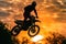 Photo of motocross jump silhouette with natural background