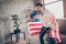 Photo of multiethnic crazy arab guy sitting sofa hold popcorn bucket raising fists supporting usa football team match