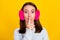 Photo of mute voiceless young woman wear earmuff hold finger lips mouth isolated on yellow color background