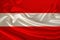 Photo of the national flag of Austria on a luxurious texture of satin, silk with waves, folds and highlights, closeup, copy space