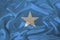 Photo of the national flag of Somalia on a luxurious texture of satin, silk with waves, folds and highlights, closeup, copy space