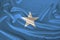 Photo of the national flag of Somalia on a luxurious texture of satin, silk with waves, folds and highlights, closeup, copy space