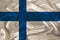 Photo of the national flag of the state of Finland on a luxurious texture of satin, silk with waves, folds and highlights, close-