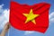 photo of the national flag of Vietnam on a luxurious texture of satin, silk with waves, folds and highlights, close-up, copy space