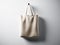 Photo natural color cotton textile bag hanging in center. Empty white wall background. Highly detailed texture, space
