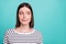 Photo of nervous anxious lady look side empty space bite lip wear striped shirt isolated on turquoise background