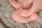 Photo of newborn baby feet, soft focus