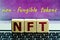 photo on nft non-fungible token theme. wooden cubes with the abbreviation `nft`, and the inscription `non-fungible tokens`