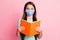 Photo of nice charming long-haired girl reading book wear respiratory teal shirt isolated pink pastel color background