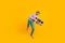 Photo of nice glad guy hold boom box dance look empty space wear purple t-shirt isolated yellow color background