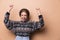 Photo of nice joyful woman in earrings smiling and dancing