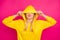 Photo of nice lady hiding eyes with hood sending air kiss wear yellow hoodie pullover isolated pink background