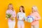 Photo of nice optimistic blond red hair grand mom daughter hold flowers present wear pastel cloth isolated on yellow