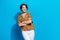 Photo of nice successful cheerful lady beaming smile crossed hands posing empty space isolated on blue color background