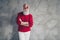 Photo of nice white haired old man crossed hands ready for x-mas party wear newyear specs red pullover white trousers