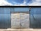 Photo of old grunge closed warehouse, blue sky on background