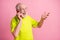 Photo of old happy cheerful excited grandfather wear lime t-shirt talk speak phone isolated on pink color background