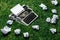 Photo of old typewriter on a green grass with a sheet of paper.