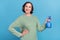 Photo of old white hair funky lady water flower wear green jumper isolated on blue color background