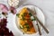 A photo of an omelette with parsley. White background with flowers