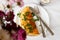 A photo of an omelette with parsley. White background with flowers