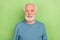 Photo of optimistic aged beard man wear blue sweater isolated on green color background
