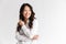 Photo of optimistic asian woman with long dark hair looking aside at copyspace and laughing, isolated over white background in st