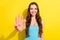 Photo of optimistic brunette hairdo young lady show three fingers wear teal top isolated on vivid yellow color