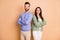 Photo of optimistic couple arms crossed wear cardigan sweater pants isolated on beige color background