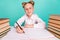 Photo of optimistic little girl write wear white shirt spectacles isolated on teal background