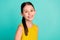 Photo of optimistic nice brown hair girl wear yellow dress isolated on bright teal color background