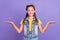 Photo of optimistic small blond girl hold hands wear yellow t-shirt jeans vest isolated on violet color background