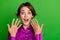 Photo of overjoyed cheerful crazy lady open mouth showing hands fingers reaction good news empy space  on green