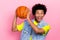 Photo of overjoyed funky person hands hold basketball open mouth good mood isolated on pink color background