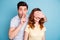 Photo of pair romance moment hide eyes finger mouth please be silent symbol request wear casual t-shirts isolated blue