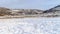 Photo Panorama Field with snow in winter with homes on snowy hill against sky backgdrop