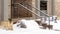 Photo Panorama frame Yard and stone stairs covered with snow at the residential building entrance