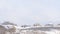 Photo Panorama Snow covered hill top with snowy houses against vast cloudy sky in winter
