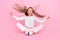 Photo of peaceful serene little lady sit floor meditate throw hair wear dotted shirt  pink color background