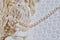 Photo of pearl string and threads on white textile textured background