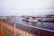 photo from the pedestrian zone of the breakwater in the port with moored yachts and ships in the background