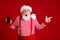 Photo of pensioner grandpa grey beard shock hold telephone direct finger empty space great sale wear santa x-mas costume
