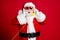 Photo of pensioner old man grey beard hold wired telephone talk collegue elves find out good news wear x-mas santa
