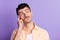 Photo of pensive minded guy finger temple look empty space wear beige shirt isolated violet color background