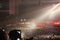 Photo of people at the concert in the great hall with their hands up